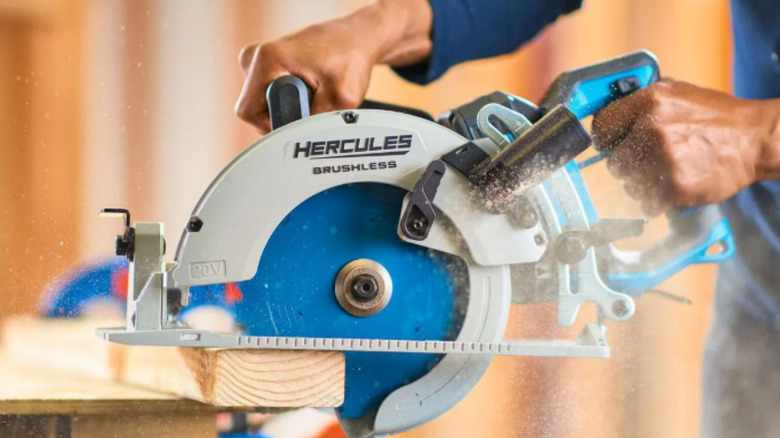 a person cuts wood with a hercules circular saw