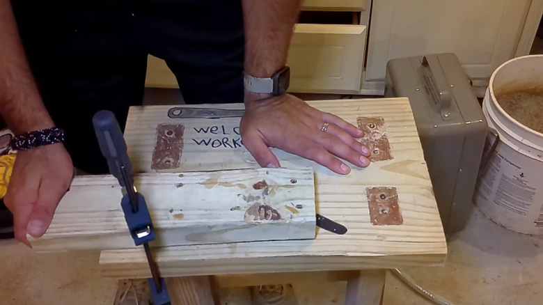 a person demonstrates how to use a clamp