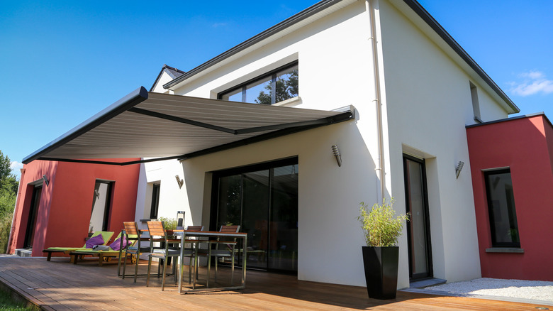 house with wood deck and awning