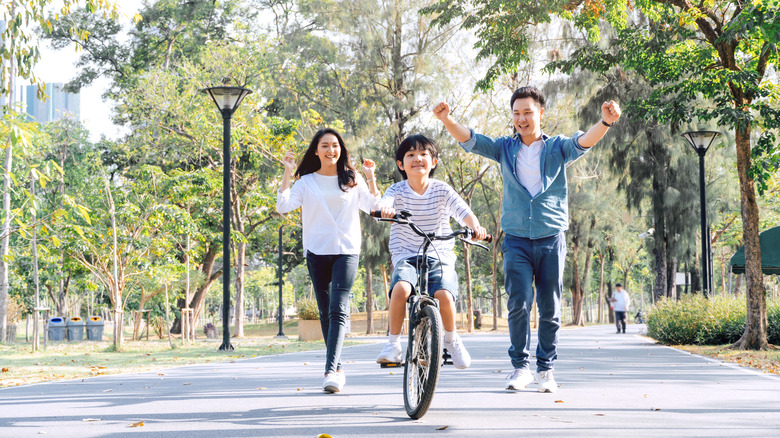 Parents with child riding bike