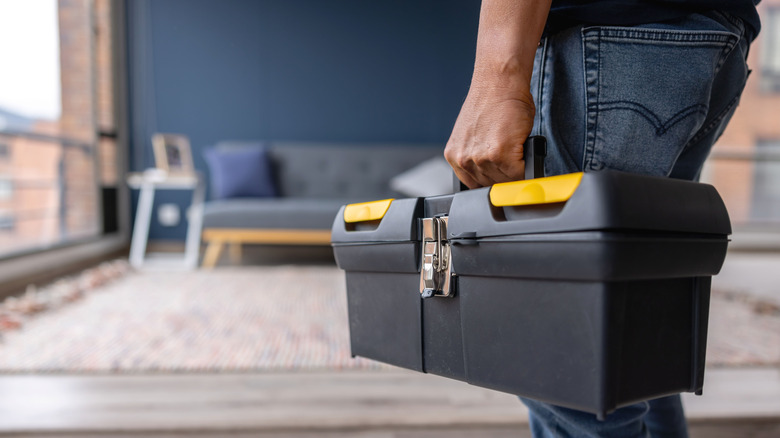 Person walking with toolbox