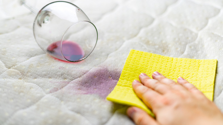 spilled coffee on mattress being blotted away