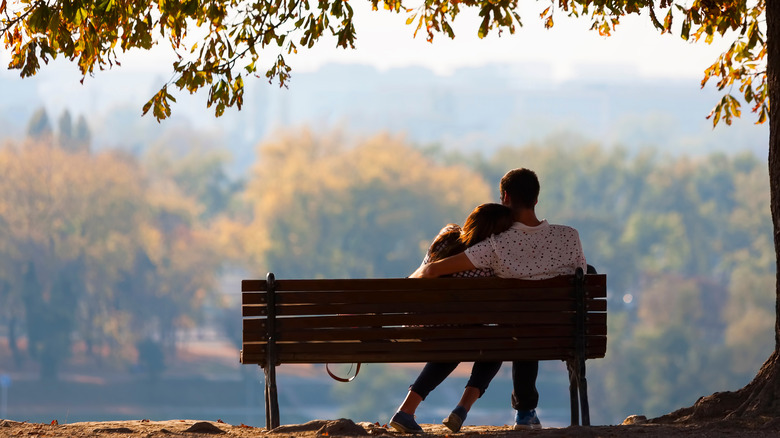 Couple hugging on bench