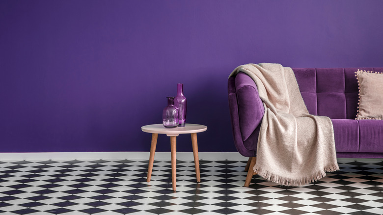 purple accent wall with couch
