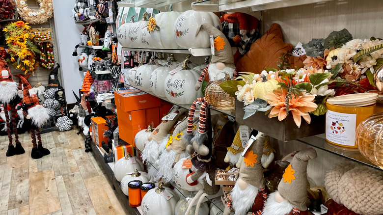 A variety of fall decor is displayed on shelves at HomeGoods