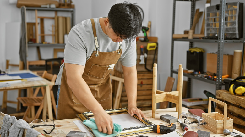 A man working at a cluttered bench