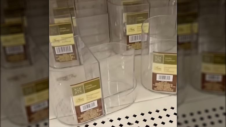 Clear vanity organizers are arranged for sale at Dollar Tree.