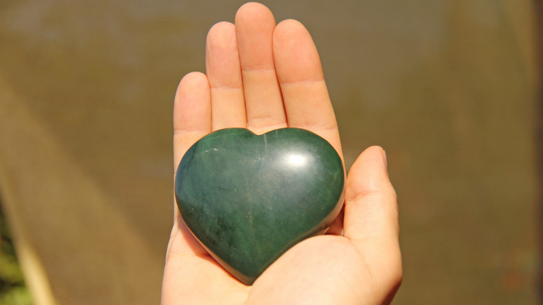hand with heart-shaped stone