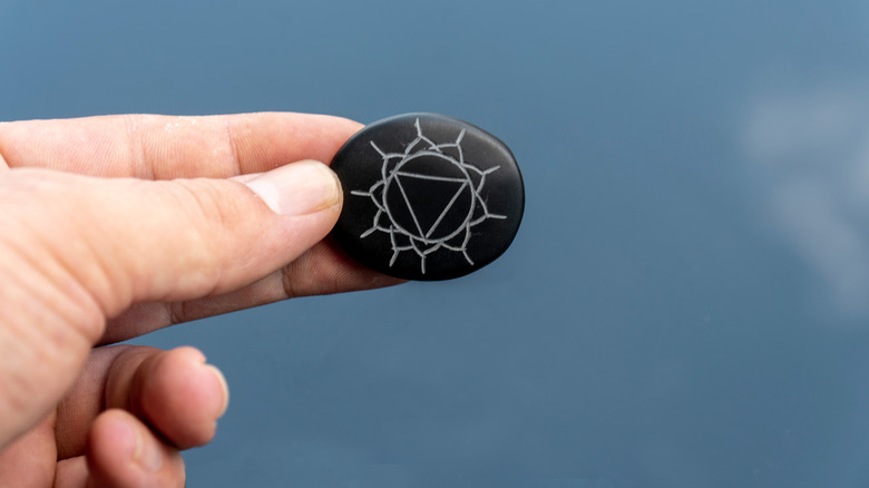 Stone with plexus chakra symbol