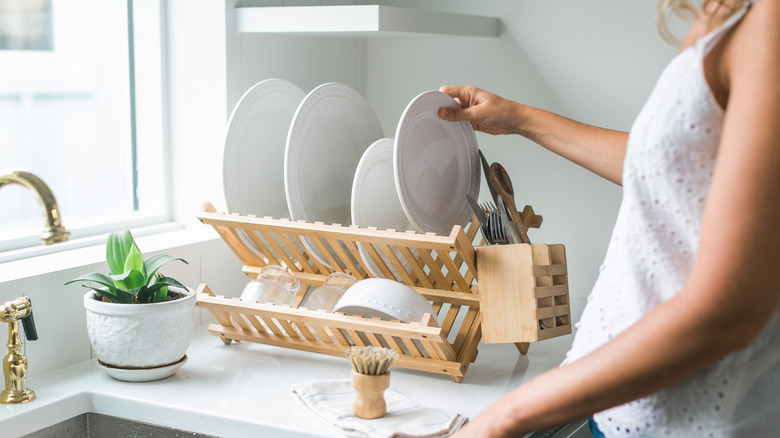 Person using dish drying rack