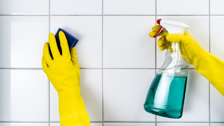 Person cleaning tile grout
