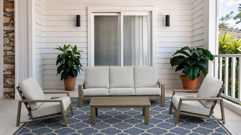 Henredon patio set on a white wood patio with pot plants
