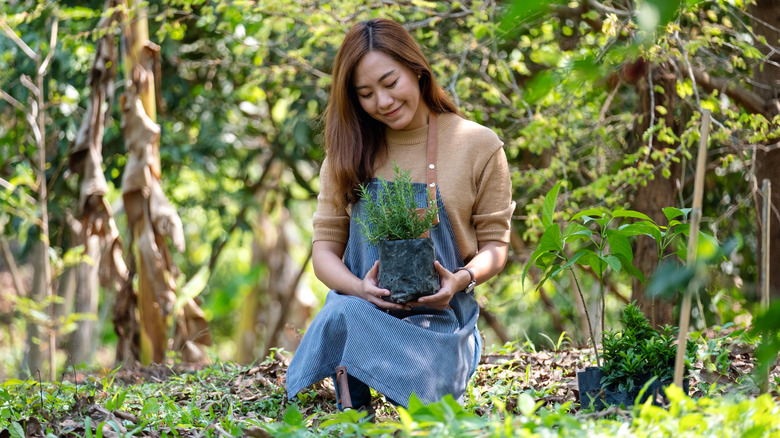 woman holding plant