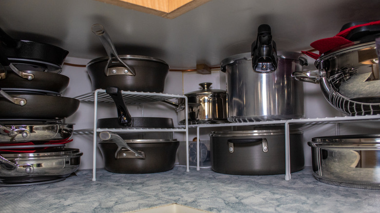 Wire racks create extra vertical storage for pots and pans