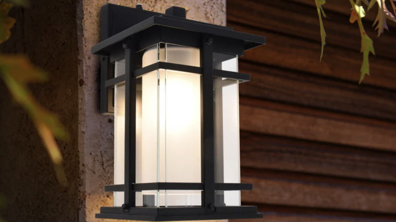 Lutec Craftsman Style Wall Lantern glowing in the evening