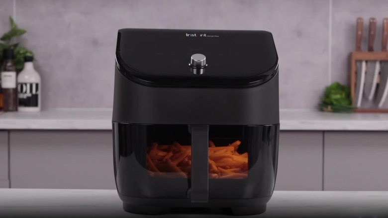A black Instant Vortex sits on a kitchen counter