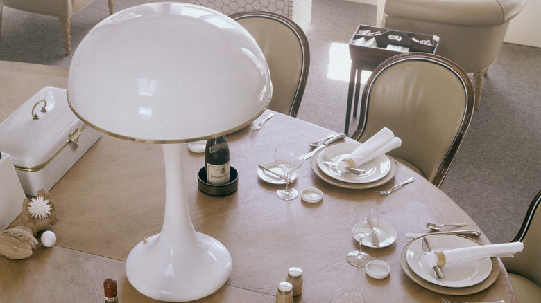 Vintage mushroom lamp at the center of a formal dining table with place settings