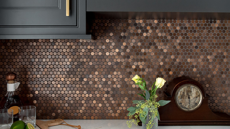 A modern kitchen with bronze penny tile.
