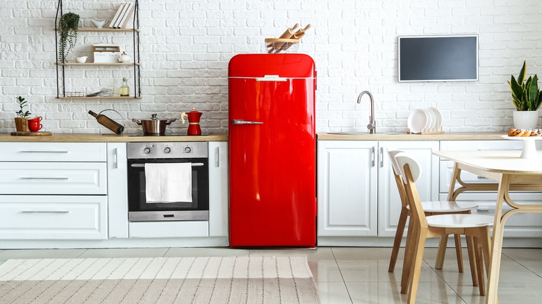 A retro kitchen with a red fridge