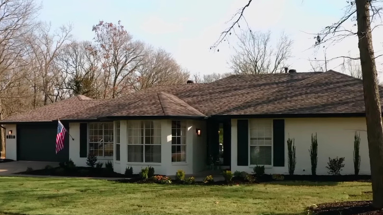 brick house painted white with black shutters
