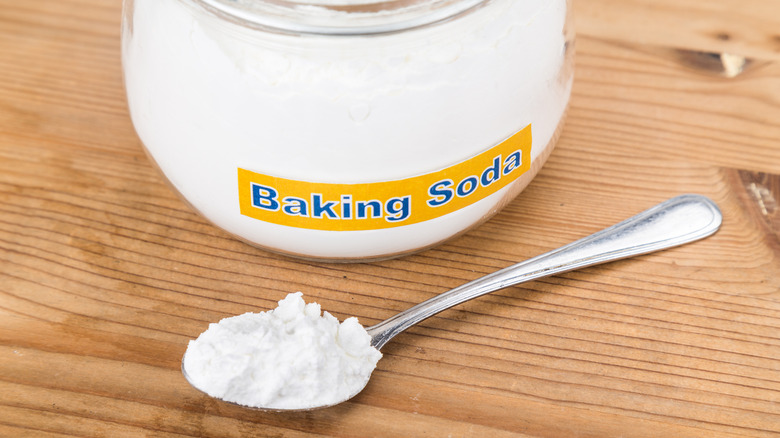 Baking soda in glass jar and spoon
