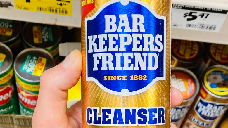 Person holding can of Bar Keeper's Friend