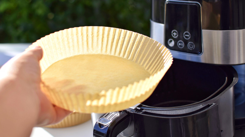 Person removing liner from air fryer