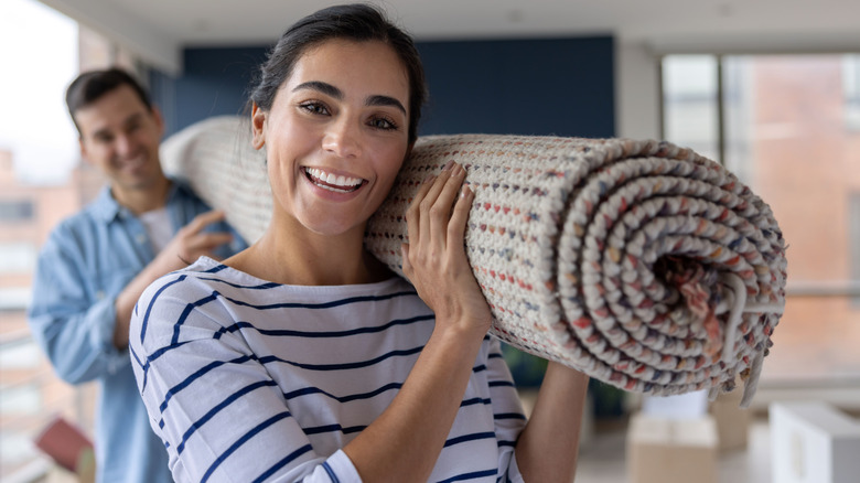 people carrying a carpet