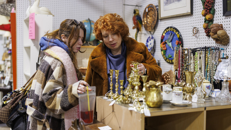 Two women browsing items at thrift store