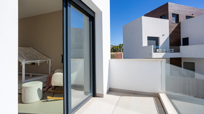 A balcony with a sliding glass door in a modern style