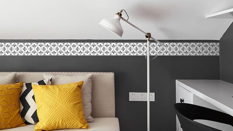 Wallpaper border along edge of sloped-ceiling bedroom
