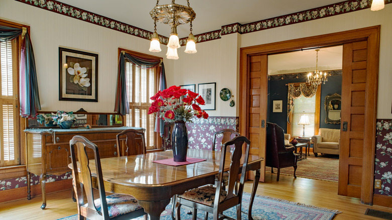 A Victorian-style room with wallpaper border below the ceiling