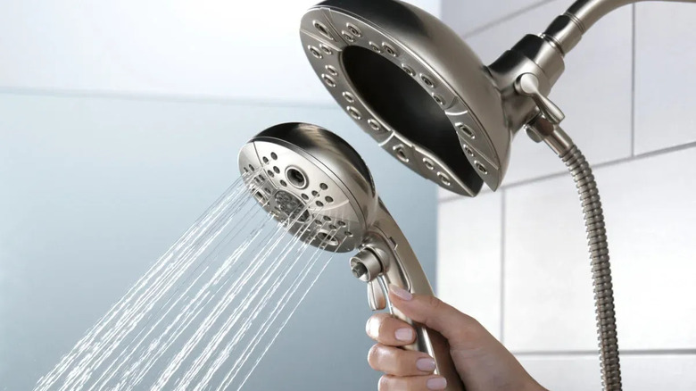 A hand holds the hand shower of the Delta H2Okinetic In2ition 5-setting Hand Shower