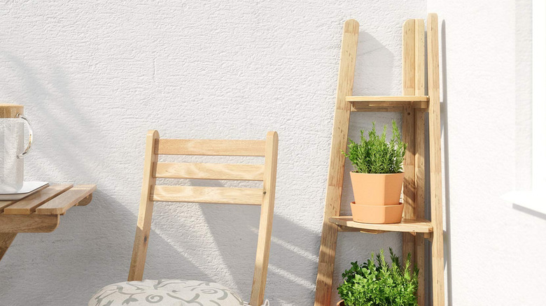Corner plant stand beside outdoor table