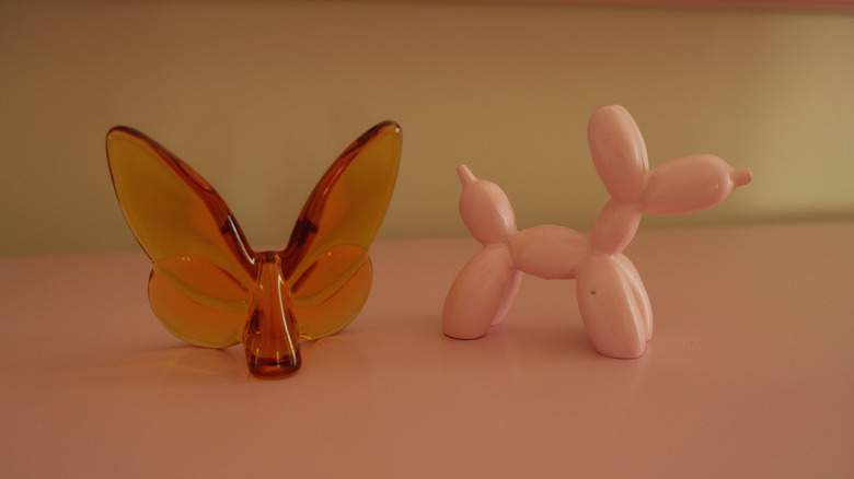 Orange glass butterfly and pink ceramic balloon dog
