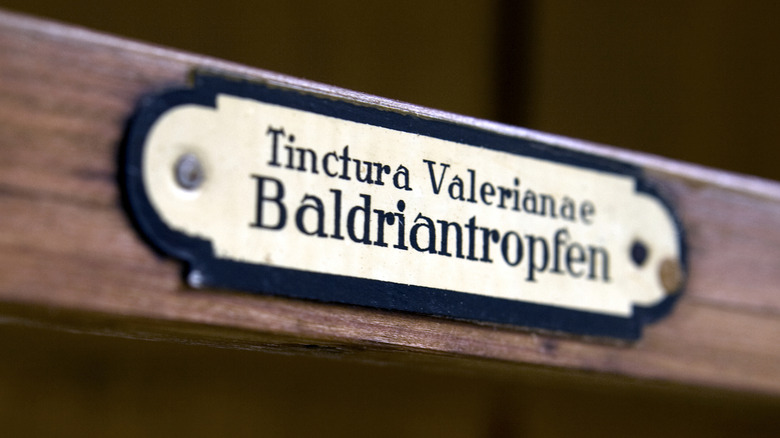 An antique bookplate label on a pharmacy shelf