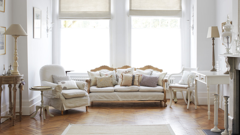 A traditional living room with ornate furniture and throw pillows