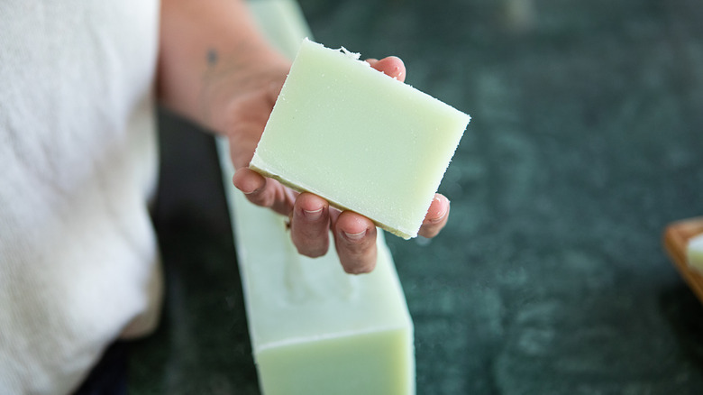 woman holding handmade bar of soap