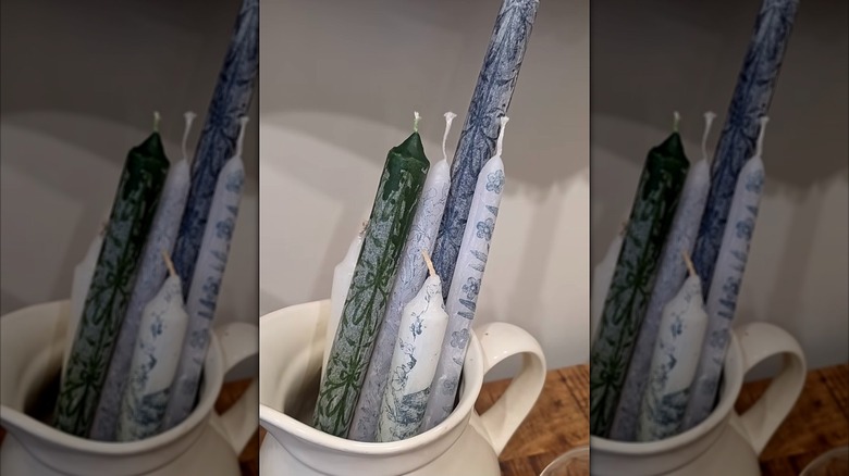 Ceramic vase containing decorated candle sticks