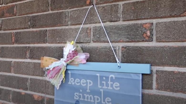 keep life simple hanging sign