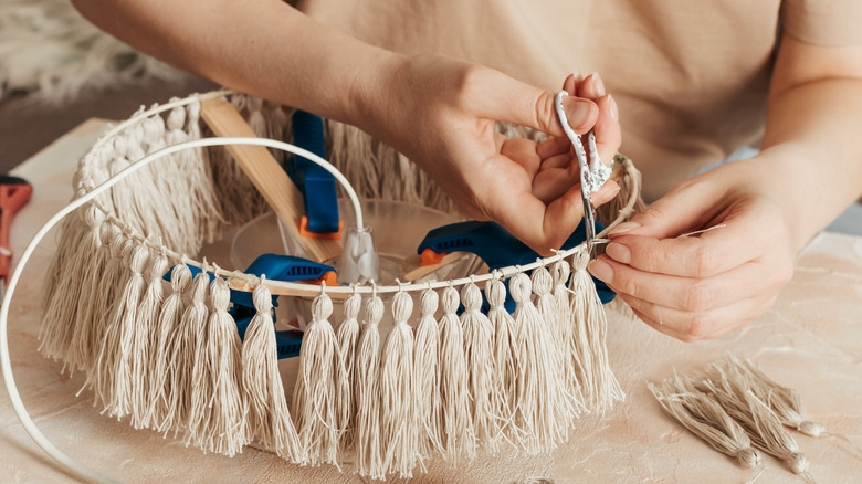 Person cutting lampshade tassels