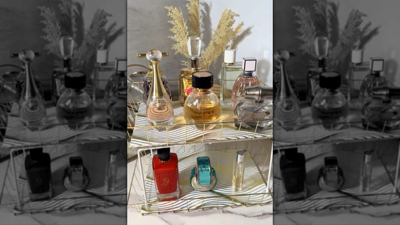 A stacking shelf made from Dollar Tree items and filled with perfumes