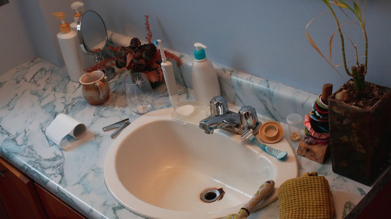 A cluttered bathroom countertop