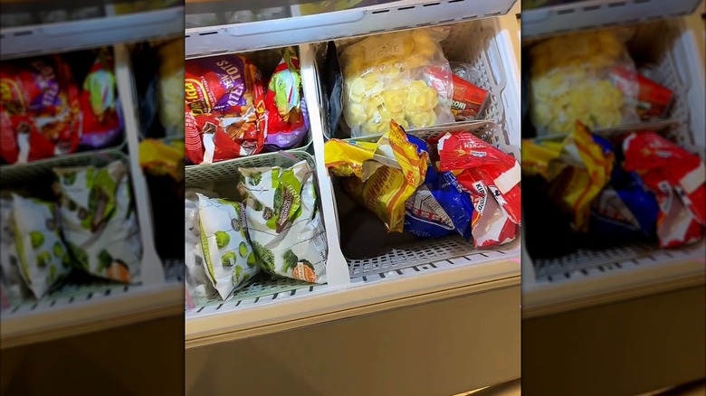 Containers filled with frozen food inside of freezer drawer