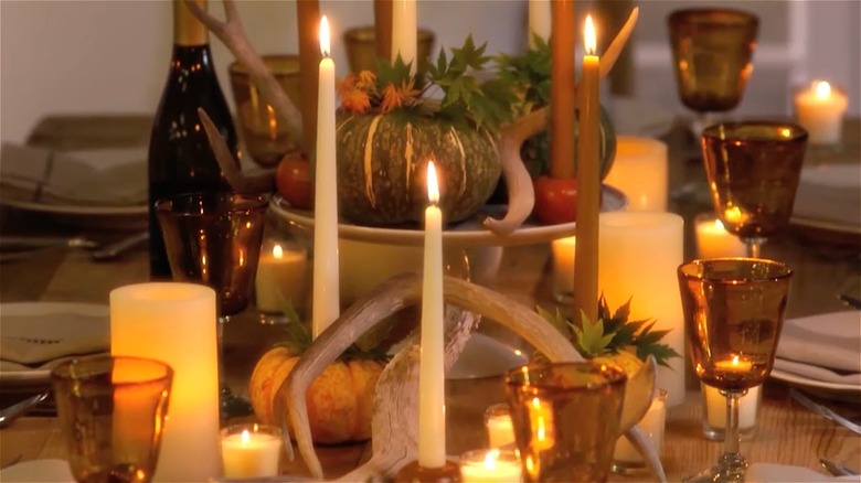 multilevel centerpiece with gourds and candles