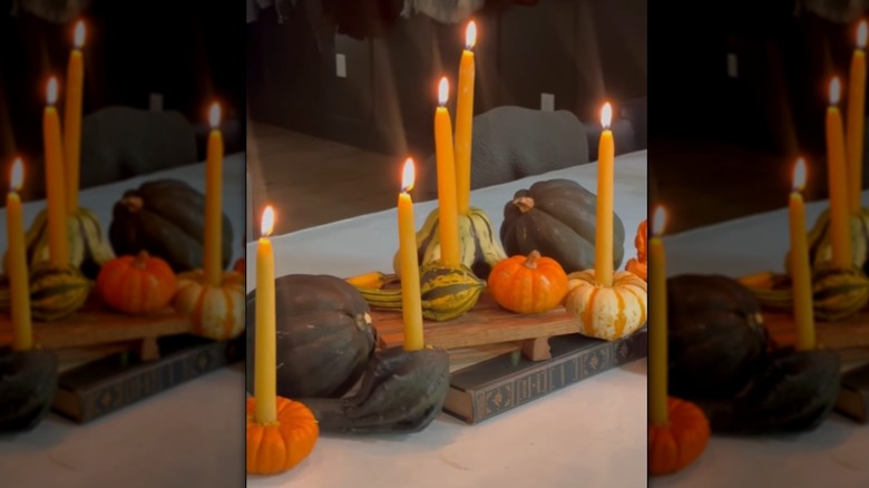 Autumn centerpiece made from candles and gourds