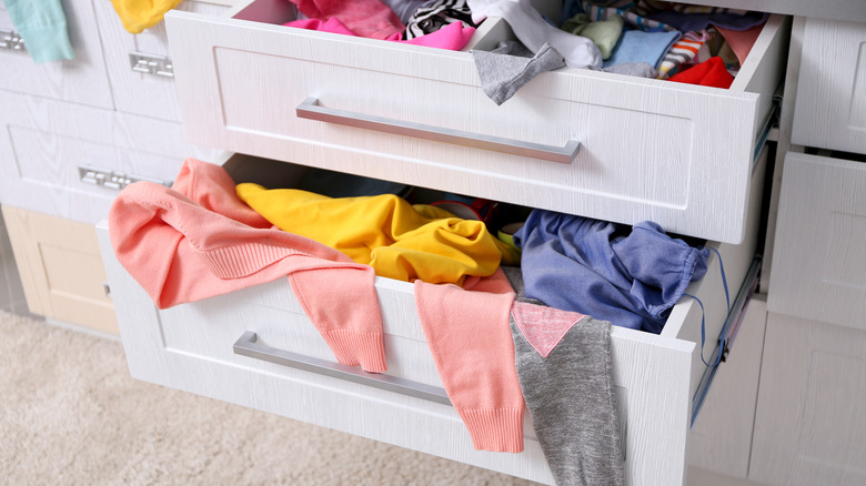 messy drawers filled with clothes 