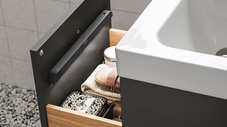 An IKEA K﻿ÖLVATTEN light strip mounted inside a bathroom vanity drawer