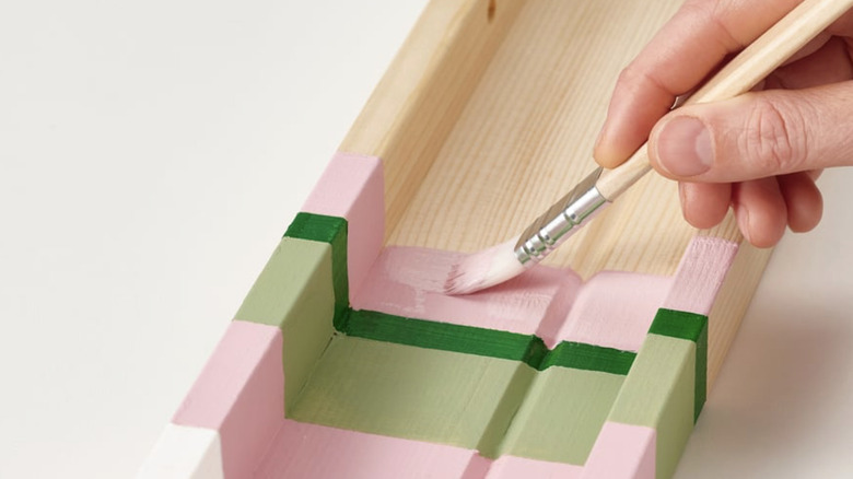 Person painting the NORDHÄGG with bright colors