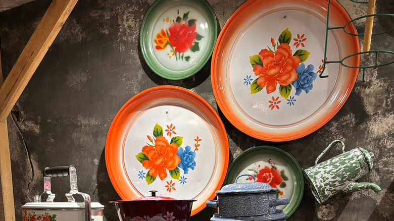 Enamelware dishes hanging on a wall